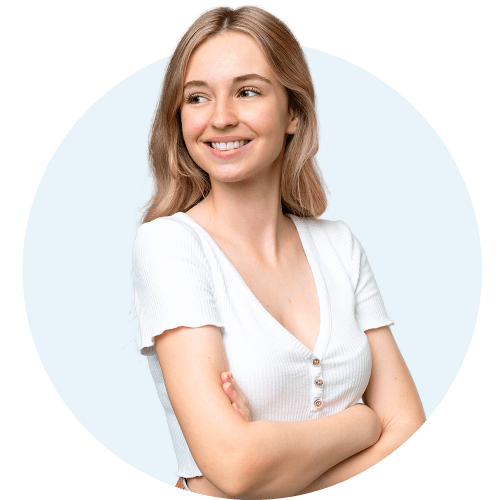 Teen girl standing with her arms crossed looking to the side and smiling.